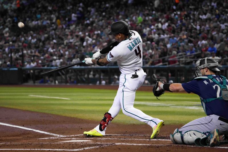 Jul 30, 2023; Phoenix, Arizona, USA; Arizona Diamondbacks second baseman Ketel Marte (4) bats against the Seattle Mariners during the first inning at Chase Field. Mandatory Credit: Joe Camporeale-USA TODAY Sports