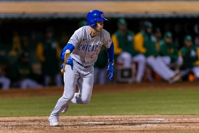 Apr 18, 2023; Oakland, California, USA; Chicago Cubs center fielder Cody Bellinger (24) hits an RBI single against the Oakland Athletics during the eighth inning at RingCentral Coliseum. Mandatory Credit: John Hefti-USA TODAY Sports