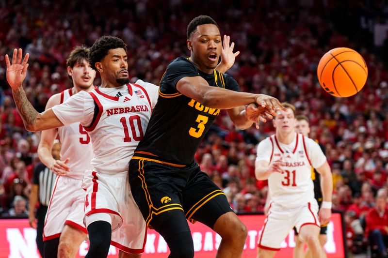 Mar 8, 2026; Lincoln, Nebraska, USA; Iowa Hawkeyes forward Cam Manyawu (3) passes against Nebraska Cornhuskers guard Jamarques Lawrence (10) during the second half at Pinnacle Bank Arena. Mandatory Credit: Dylan Widger-Imagn Images