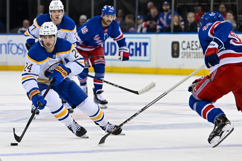 Nov 7, 2024; New York, New York, USA;  Buffalo Sabres center Dylan Cozens (24) skates across the blue line defend by New York Rangers center Mika Zibanejad (93) during the first period at Madison Square Garden. Mandatory Credit: Dennis Schneidler-Imagn Images