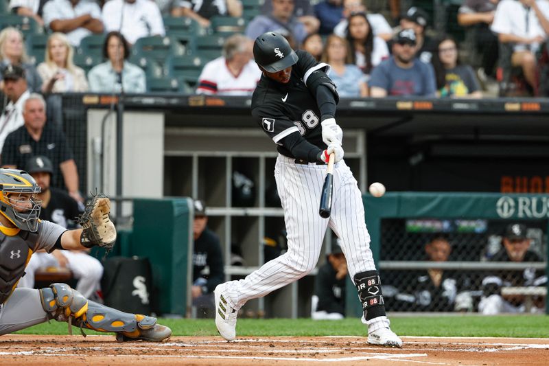 Aug 26, 2023; Chicago, Illinois, USA; Chicago White Sox center fielder Luis Robert Jr. (88) hits a double against the Oakland Athletics during the first inning at Guaranteed Rate Field. Mandatory Credit: Kamil Krzaczynski-USA TODAY Sports