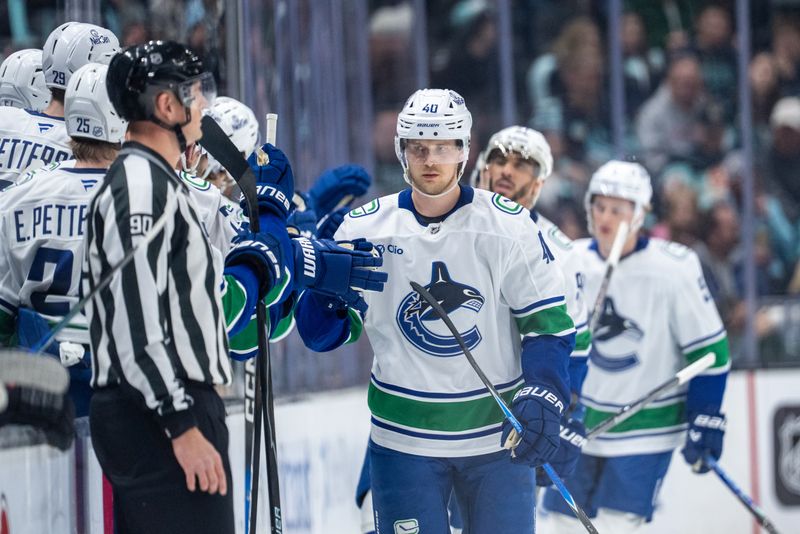 Dec 29, 2025; Seattle, Washington, USA; Vancouver Canucks forward Elias Pettersson (40) is congratulated by teammates on the bench after scoring a goal during the second period against the Seattle Kraken at Climate Pledge Arena. Mandatory Credit: Stephen Brashear-Imagn Images