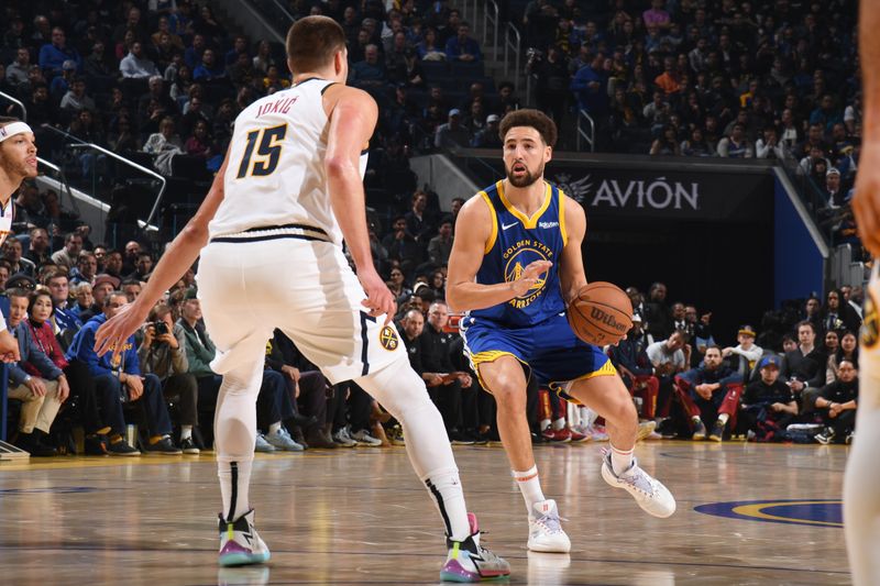 SAN FRANCISCO, CA - JANUARY 4: Klay Thompson #11 of the Golden State Warriors handles the ball during the game against the Denver Nuggets on January 4, 2024 at Chase Center in San Francisco, California. NOTE TO USER: User expressly acknowledges and agrees that, by downloading and or using this photograph, user is consenting to the terms and conditions of Getty Images License Agreement. Mandatory Copyright Notice: Copyright 2024 NBAE (Photo by Noah Graham/NBAE via Getty Images)