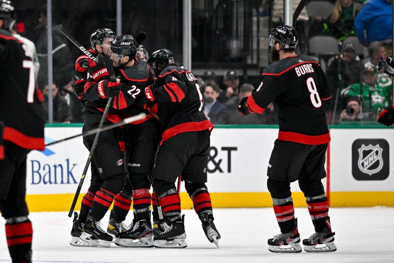 Jan 25, 2023; Dallas, Texas, USA; Carolina Hurricanes defenseman Brett Pesce (22) and defenseman Jalen Chatfield (5) and defenseman Brent Burns (8) celebrate scoring the game winning goal against the Dallas Stars during the overtime period at the American Airlines Center. Mandatory Credit: Jerome Miron-USA TODAY Sports