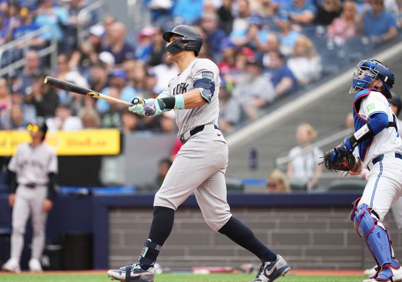 Jun 30, 2024; Toronto, Ontario, CAN; New York Yankees designated hitter Aaron Judge (99) reacts after hitting a two run home run against the Toronto Blue Jays during the first inning at Rogers Centre. Mandatory Credit: Nick Turchiaro-USA TODAY Sports