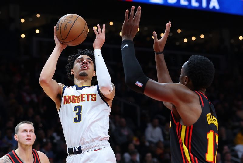 ATLANTA, GEORGIA - DECEMBER 11:  Julian Strawther #3 of the Denver Nuggets attacks the basket against Onyeka Okongwu #17 of the Atlanta Hawks during the second quarter at State Farm Arena on December 11, 2023 in Atlanta, Georgia.  NOTE TO USER: User expressly acknowledges and agrees that, by downloading and/or using this photograph, user is consenting to the terms and conditions of the Getty Images License Agreement.  (Photo by Kevin C. Cox/Getty Images)