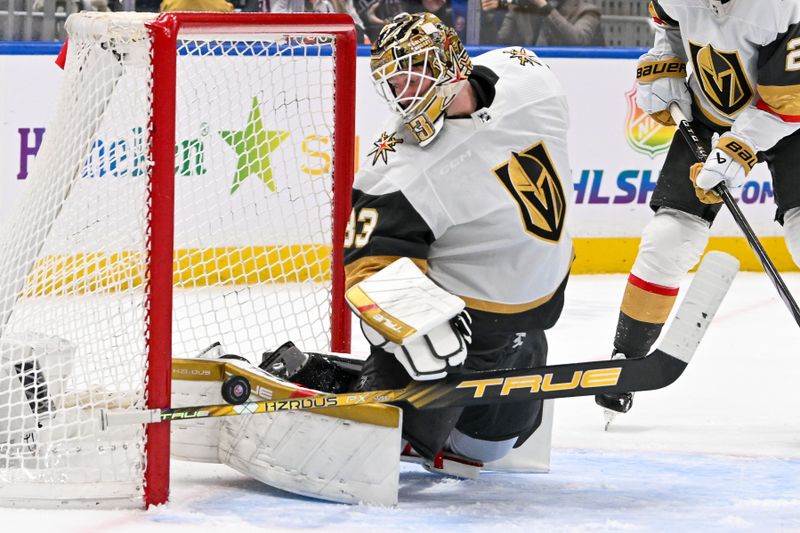 Jan 23, 2024; Elmont, New York, USA;  Vegas Golden Knights goaltender Adin Hill (33) makes a save against the New York Islanders during the second period at UBS Arena. Mandatory Credit: Dennis Schneidler-USA TODAY Sports