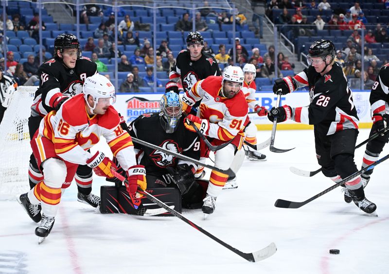 Nov 19, 2025; Buffalo, New York, USA; Buffalo Sabres defenseman Rasmus Dahlin (26) and Calgary Flames left wing Joel Farabee (86) with center Nazem Kadri (91) go for the puck in front of Buffalo Sabres goaltender Colten Ellis (92) in the third period at KeyBank Center. Mandatory Credit: Mark Konezny-Imagn Images