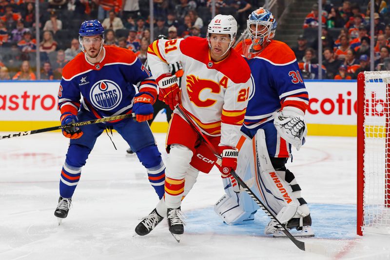 Sep 23, 2024; Edmonton, Alberta, CAN; Calgary Flames forward Kevin Rooney (21) tries to screen Edmonton Oilers goaltender Calvin Pickard (30) during the second period at Rogers Place. Mandatory Credit: Perry Nelson-Imagn Images