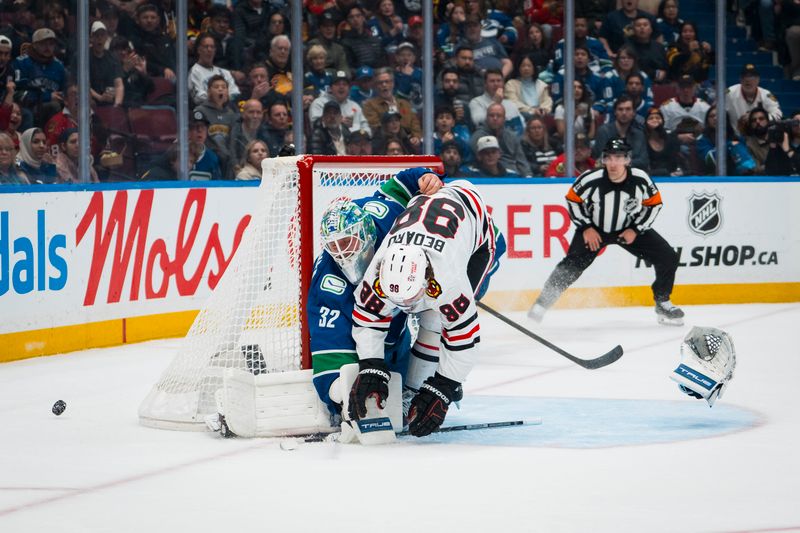 Nov 5, 2025; Vancouver, British Columbia, CAN; Chicago Blackhawks forward Connor Bedard (98) collides with Vancouver Canucks goalie Kevin Lankinen (32) in the first period at Rogers Arena. Mandatory Credit: Bob Frid-Imagn Images