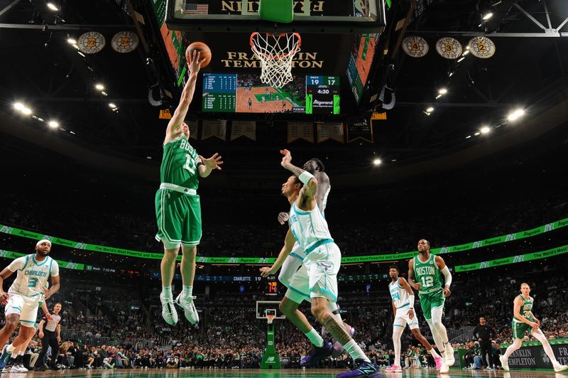 BOSTON, MA - APRIL 12:  Payton Pritchard #11 of the Boston Celtics drives to the basket during the game against the Charlotte Hornets on April 12, 2024 at the TD Garden in Boston, Massachusetts. NOTE TO USER: User expressly acknowledges and agrees that, by downloading and or using this photograph, User is consenting to the terms and conditions of the Getty Images License Agreement. Mandatory Copyright Notice: Copyright 2024 NBAE  (Photo by Brian Babineau/NBAE via Getty Images)