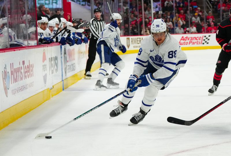 Mar 24, 2024; Raleigh, North Carolina, USA;  Toronto Maple Leafs right wing William Nylander (88) skates with the puck against the Carolina Hurricanes during the second period at PNC Arena. Mandatory Credit: James Guillory-USA TODAY Sports