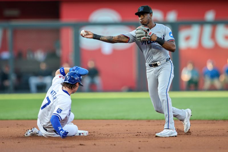 Jun 24, 2024; Kansas City, Missouri, USA; Miami Marlins shortstop Tim Anderson (7) throws to first base over Kansas City Royals shortstop Bobby Witt Jr. (7) for a double play during the first inning at Kauffman Stadium. Mandatory Credit: William Purnell-USA TODAY Sports