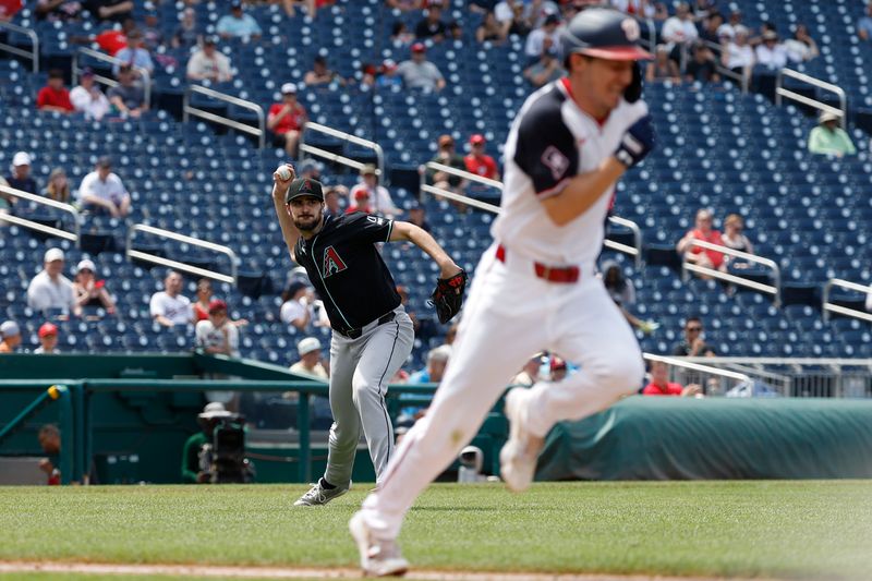 Jun 20, 2024; Washington, District of Columbia, USA; Arizona Diamondbacks pitcher Ryan Thompson (81) makes a throw to first base on a bunt by Washington Nationals outfielder Jacob Young (30) during the eighth inning at Nationals Park. Mandatory Credit: Geoff Burke-USA TODAY Sports