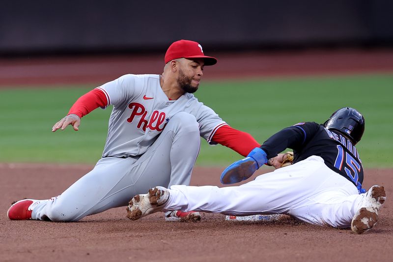 Sep 30, 2023; New York City, New York, USA; New York Mets left fielder Danny Mendick (15) steals second base ahead of a tag by Philadelphia Phillies shortstop Edmundo Sosa (33) during the seventh inning at Citi Field. Mandatory Credit: Brad Penner-USA TODAY Sports