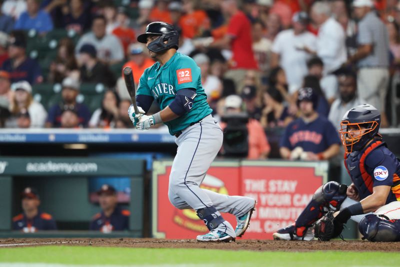 May 25, 2025; Houston, Texas, USA; Seattle Mariners first baseman Donovan Solano (39) hits an RBI single during the third inning against the Houston Astros at Daikin Park. Mandatory Credit: Troy Taormina-Imagn Images