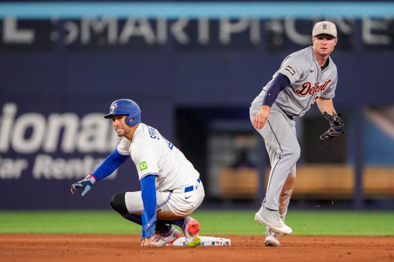 May 17, 2025; Toronto, Ontario, CAN; Detroit Tigers second base Colt Keith (33) throws to first as Toronto Blue Jays outfielder George Springer (4) slides into second base during the seventh inning in their MLB game at Rogers Centre. Mandatory Credit: Kevin Sousa-Imagn Images
