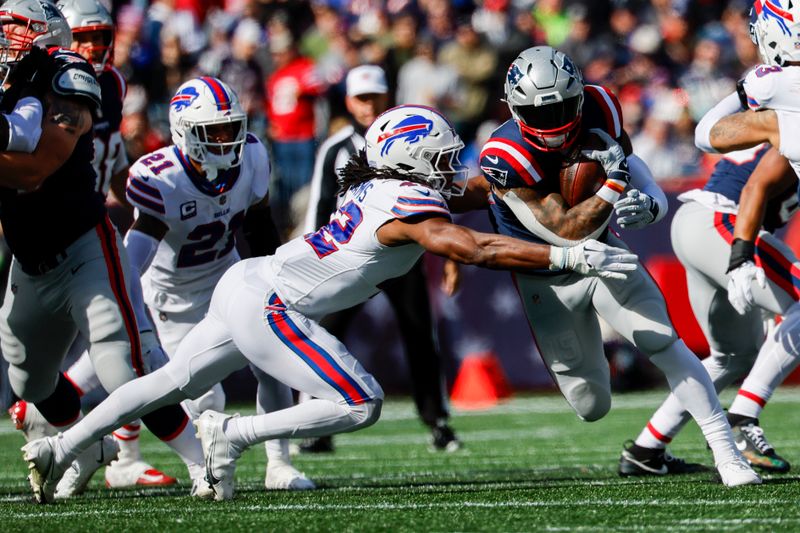 New England Patriots running back Ezekiel Elliott (15) is tackled by Buffalo Bills linebacker Dorian Williams (42) during the first half of an NFL football game on Sunday, Oct. 22, 2023, in Foxborough, Mass. (AP Photo/Greg M. Cooper)