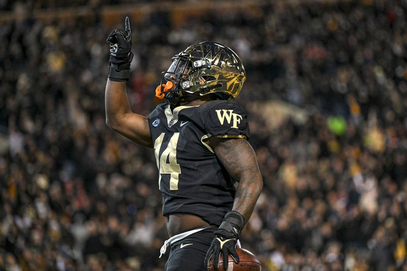 Nov 13, 2021; Winston-Salem, North Carolina, USA; Wake Forest Demon Deacons running back Justice Ellison (14) celebrates after scoring a touchdown against the North Carolina State Wolfpack during the first half at Truist Field. Mandatory Credit: William Howard-USA TODAY Sports