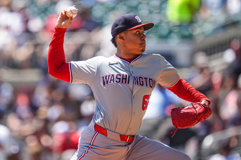 Aug 25, 2024; Cumberland, Georgia, USA; Washington Nationals relief pitcher Eduardo Salazar (62) pitches against the Atlanta Braves during the seventh inning at Truist Park. Mandatory Credit: Dale Zanine-USA TODAY Sports