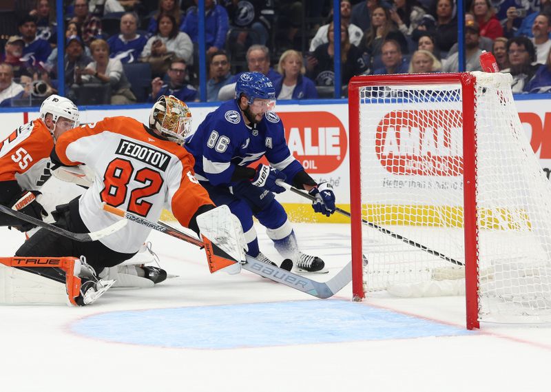 Nov 7, 2024; Tampa, Florida, USA; Tampa Bay Lightning right wing Nikita Kucherov (86) skates around Philadelphia Flyers goaltender Ivan Fedotov (82) as he scores a goal during the first period at Amalie Arena. Mandatory Credit: Kim Klement Neitzel-Imagn Images