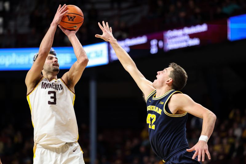 Jan 16, 2025; Minneapolis, Minnesota, USA; Minnesota Golden Gophers forward Dawson Garcia (3) shoots as Michigan Wolverines forward Will Tschetter (42) defends during the first half at Williams Arena. Mandatory Credit: Matt Krohn-Imagn Images