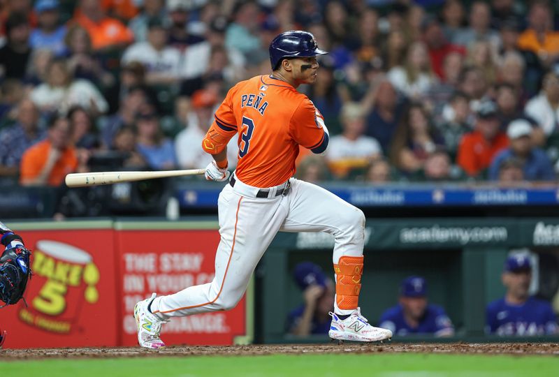 Apr 12, 2024; Houston, Texas, USA; Houston Astros shortstop Jeremy Pena (3) hits a single during the fourth inning against the Texas Rangers at Minute Maid Park. Mandatory Credit: Troy Taormina-USA TODAY Sports