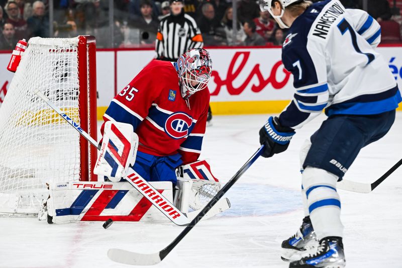 Jan 28, 2025; Montreal, Quebec, CAN; Montreal Canadiens goalie Sam Montembeault (35) makes a save against Winnipeg Jets center Vladislav Namestnikov (7) during the first period at Bell Centre. Mandatory Credit: David Kirouac-Imagn Images