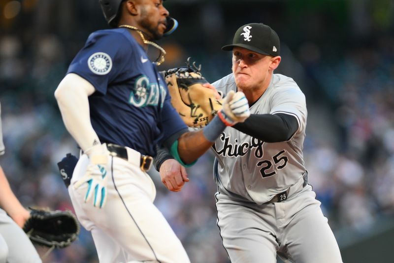 Jun 12, 2024; Seattle, Washington, USA; Chicago White Sox first baseman Andrew Vaughn (25) tags out Seattle Mariners second baseman Ryan Bliss (1) at first base during the eighth inning at T-Mobile Park. Mandatory Credit: Steven Bisig-USA TODAY Sports