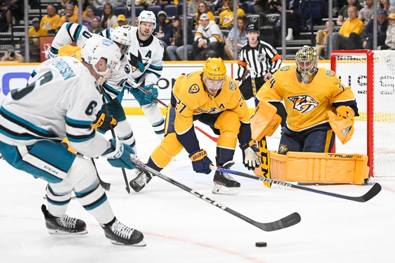 Oct 21, 2023; Nashville, Tennessee, USA; Nashville Predators defenseman Ryan McDonagh (27) and goaltender Juuse Saros (74) defend the goal against the San Jose Sharks during the second period at Bridgestone Arena. Mandatory Credit: Steve Roberts-USA TODAY Sports