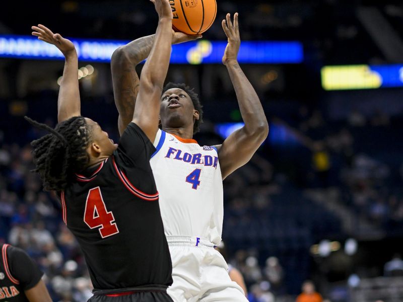 Mar 14, 2024; Nashville, TN, USA;  Florida Gators forward Tyrese Samuel (4) shoots over Georgia Bulldogs guard Silas Demary Jr. (4) during the second half at Bridgestone Arena. Mandatory Credit: Steve Roberts-USA TODAY Sports