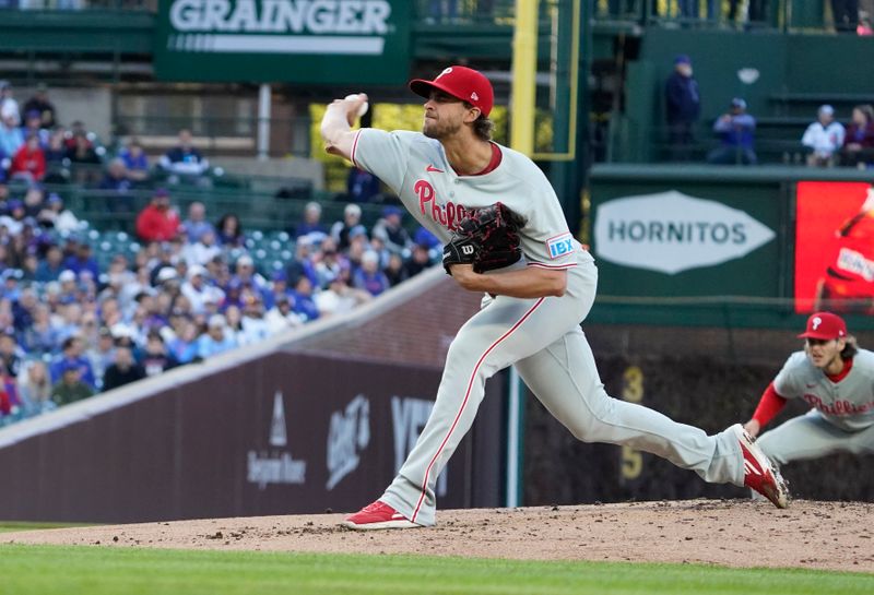 Apr 27, 2025; Chicago, Illinois, USA; Philadelphia Phillies pitcher Aaron Nola (27) throws the ball against the Chicago Cubs during the first inning at Wrigley Field. Mandatory Credit: David Banks-Imagn Images