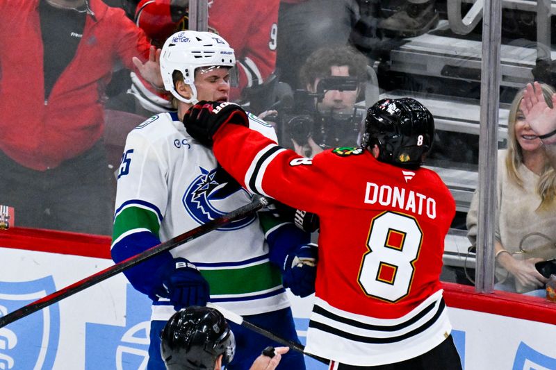 Oct 17, 2025; Chicago, Illinois, USA;  Chicago Blackhawks center Ryan Donato (8) punches Vancouver Canucks defenseman Elias Pettersson (25) during the second period at the United Center. Mandatory Credit: Matt Marton-Imagn Images