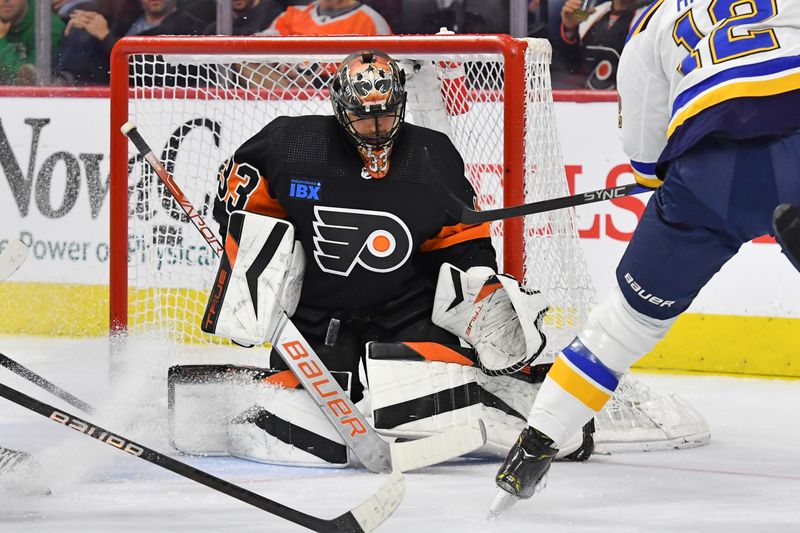 Mar 4, 2024; Philadelphia, Pennsylvania, USA; Philadelphia Flyers goaltender Samuel Ersson (33) makes a save against St. Louis Blues right wing Kevin Hayes (12) during the first period at Wells Fargo Center. Mandatory Credit: Eric Hartline-USA TODAY Sports