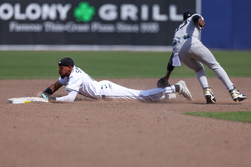 Apr 20, 2025; Tampa, Florida, USA; Tampa Bay Rays center fielder Chandler Simpson (14) steals second base against the New York Yankees in the eighth inning at George M. Steinbrenner Field. Mandatory Credit: Nathan Ray Seebeck-Imagn Images