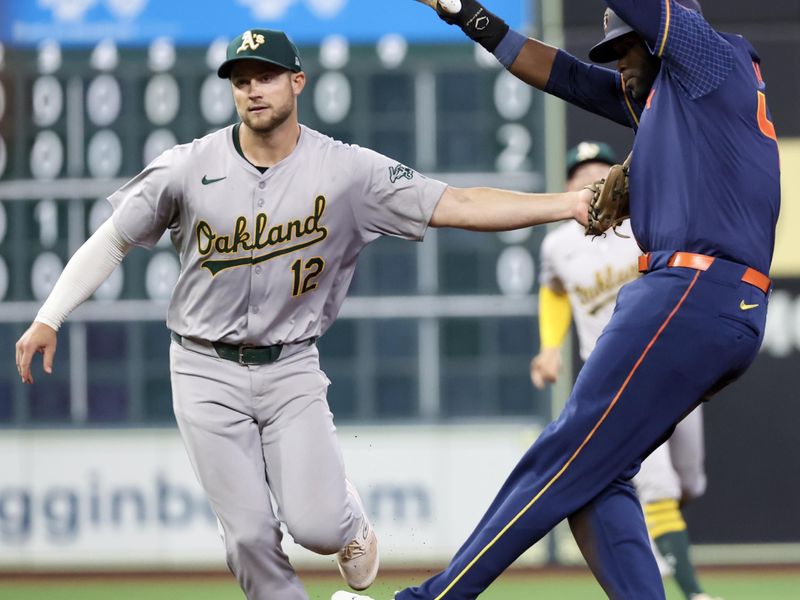 May 13, 2024; Houston, Texas, USA; Houston Astros left fielder Yordan Alvarez (44) is tagged out by Oakland Athletics shortstop Max Schuemann (12) in a run down in the sixth inning at Minute Maid Park. Mandatory Credit: Thomas Shea-USA TODAY Sports