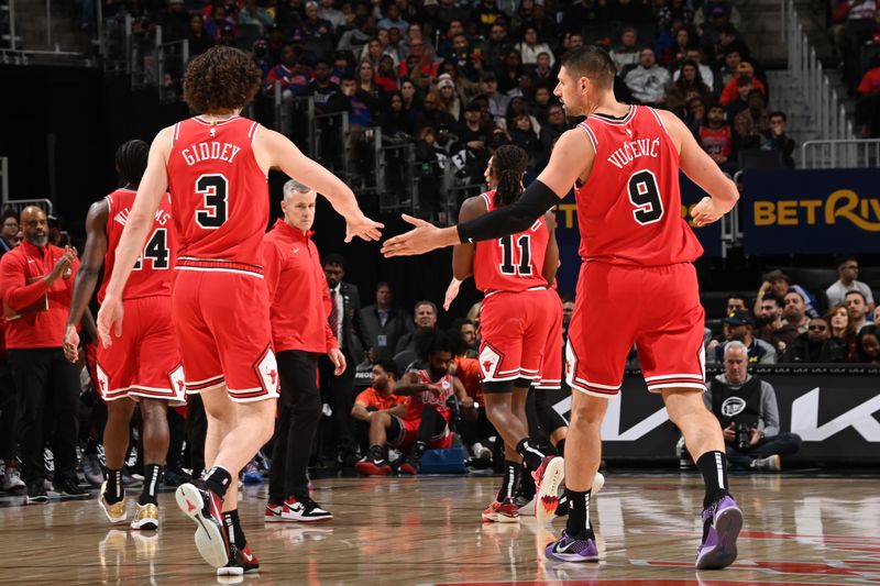 DETROIT, MI - NOVEMBER 18: Josh Giddey #3 and Nikola Vucevic #9 of the Chicago Bulls high five during the game against the Detroit Pistons on November 18, 2024 at Little Caesars Arena in Detroit, Michigan. NOTE TO USER: User expressly acknowledges and agrees that, by downloading and/or using this photograph, User is consenting to the terms and conditions of the Getty Images License Agreement. Mandatory Copyright Notice: Copyright 2024 NBAE (Photo by Chris Schwegler/NBAE via Getty Images)