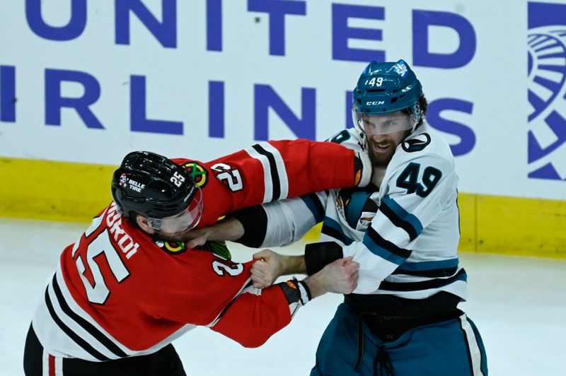 Jan 16, 2024; Chicago, Illinois, USA; San Jose Sharks right wing Scott Sabourin (49) and Chicago Blackhawks defenseman Jarred Tinordi (25) fight during the second period at United Center. Mandatory Credit: Matt Marton-USA TODAY Sports