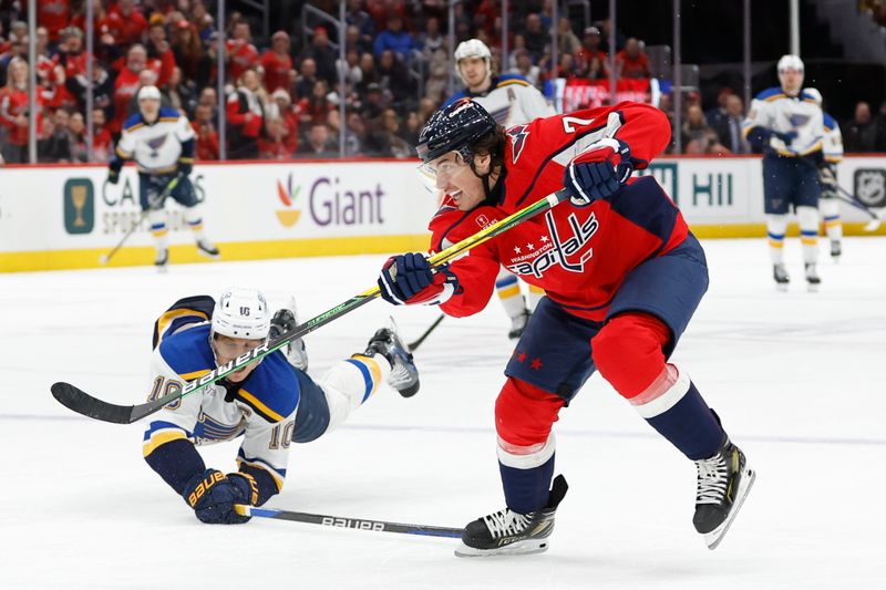 Jan 18, 2024; Washington, District of Columbia, USA; Washington Capitals right wing T.J. Oshie (77) scores an empty net goal as St. Louis Blues center Brayden Schenn (10) defends in the third period at Capital One Arena. Mandatory Credit: Geoff Burke-USA TODAY Sports