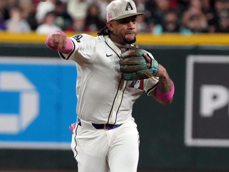 May 18, 2025; Phoenix, Arizona, USA; Arizona Diamondbacks second base Ketel Marte (4) makes the play against the Colorado Rockies in the sixth inning at Chase Field. Mandatory Credit: Rick Scuteri-Imagn Images