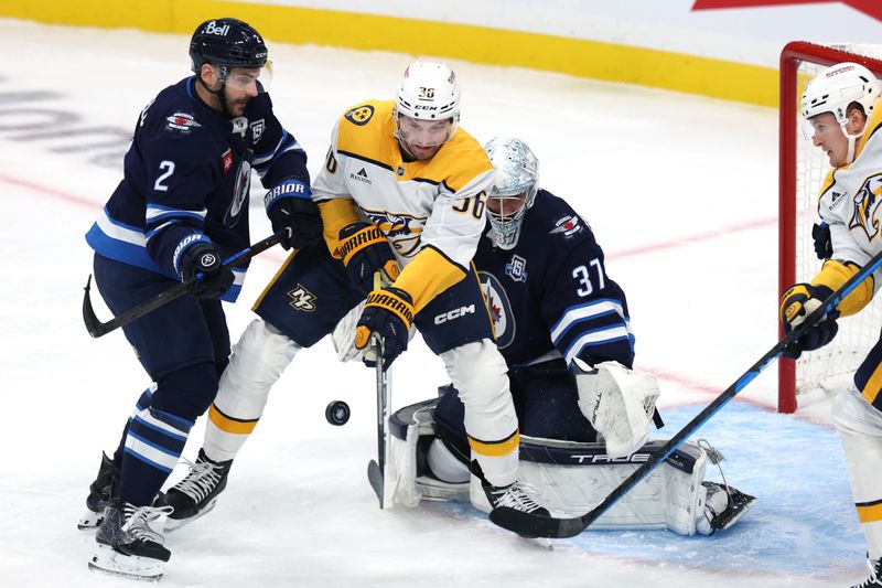 Oct 18, 2025; Winnipeg, Manitoba, CAN; Winnipeg Jets defenseman Dylan Demelo (2) and Nashville Predators left wing Cole Smith (36) fight for a rebound in front of Winnipeg Jets goaltender Connor Hellebuyck (37) in the first period at Canada Life Centre. Mandatory Credit: James Carey Lauder-Imagn Images