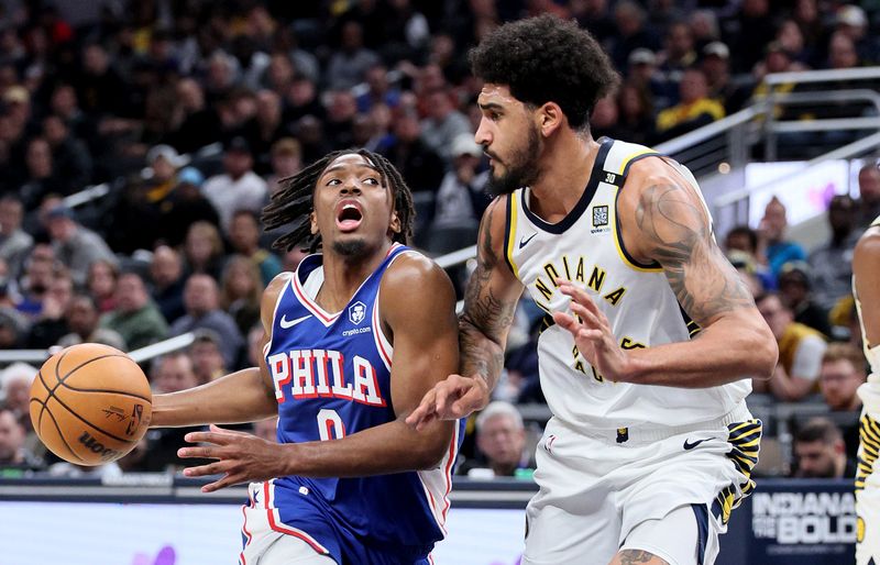 INDIANAPOLIS, INDIANA - JANUARY 25: Tyrese Maxey #0 of the Philadelphia 76ers dribbles the ball in the first half  while defended by Obi Toppin #1of the Indiana Pacers at Gainbridge Fieldhouse on January 25, 2024 in Indianapolis, Indiana.    NOTE TO USER: User expressly acknowledges and agrees that, by downloading and or using this photograph, User is consenting to the terms and conditions of the Getty Images License Agreement.  (Photo by Andy Lyons/Getty Images)