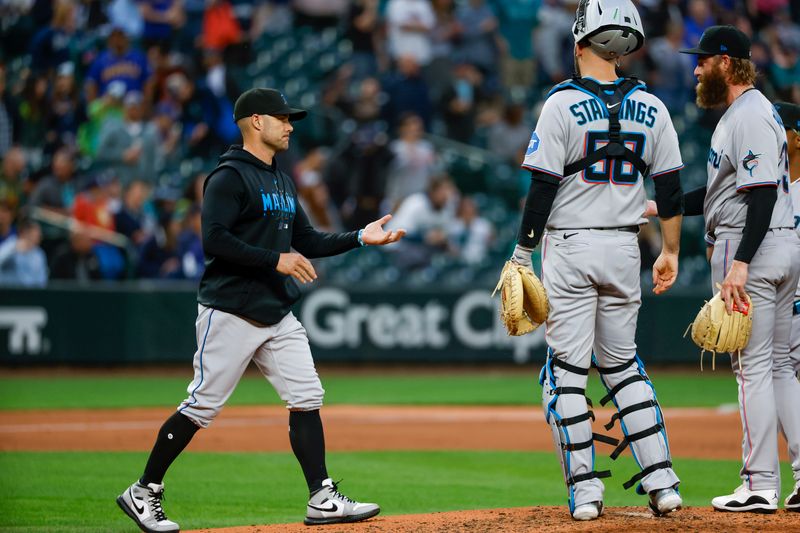 Jun 13, 2023; Seattle, Washington, USA; Miami Marlins manager Skip Schumaker (55) takes the ball from relief pitcher Archie Bradley (25) during a sixth inning pitching change against the Seattle Mariners at T-Mobile Park. Mandatory Credit: Joe Nicholson-USA TODAY Sports