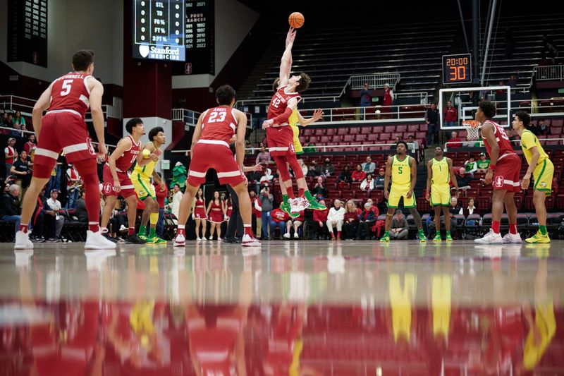 Jan 21, 2023; Stanford, California, USA; Stanford Cardinal forward Maxime Raynaud (42) and Oregon Ducks center Nate Bittle (32) jump for the opening tip-off during the first half at Maples Pavilion. Mandatory Credit: Robert Edwards-USA TODAY Sports