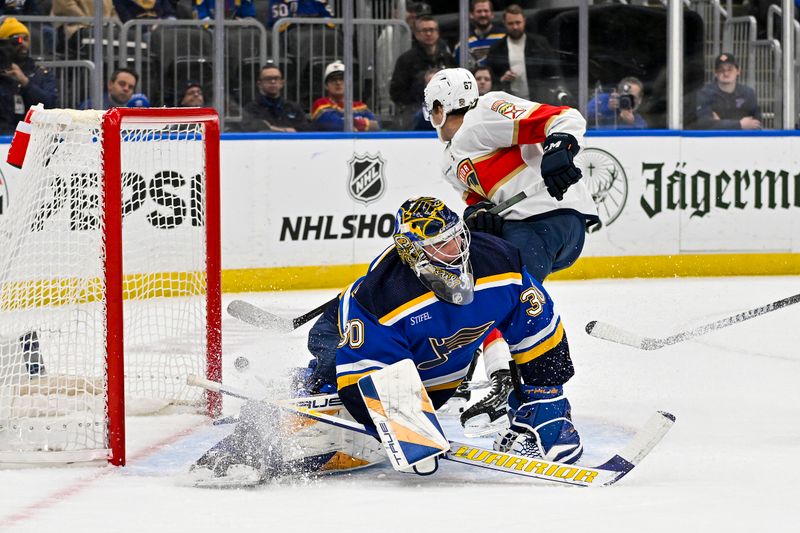 Jan 9, 2024; St. Louis, Missouri, USA;  St. Louis Blues goaltender Joel Hofer (30) defends the net against Florida Panthers right wing William Lockwood (67) during the first period at Enterprise Center. Mandatory Credit: Jeff Curry-USA TODAY Sports