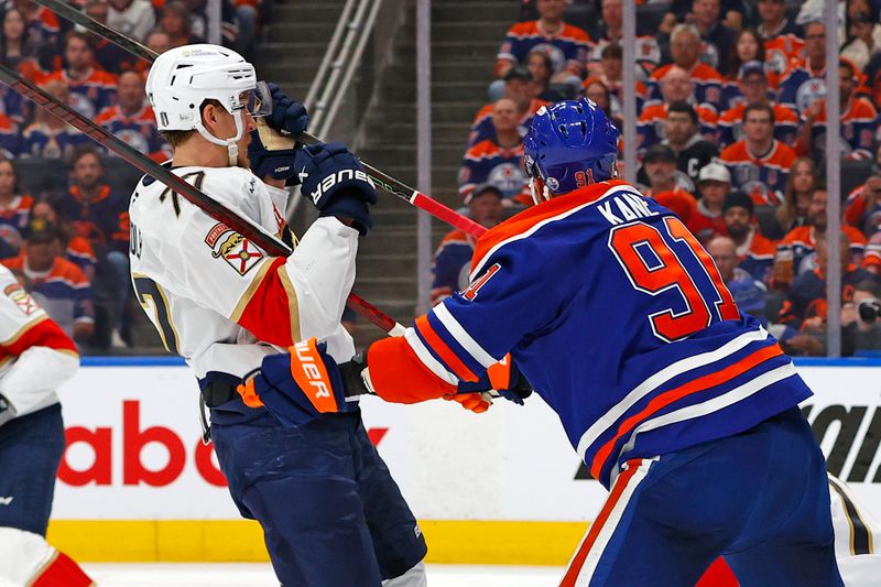 Jun 6, 2025; Edmonton, Alberta, CAN; Edmonton Oilers left wing Evander Kane (91) checks Florida Panthers defenseman Niko Mikkola (77) during the first period in game two of the 2025 Stanley Cup Final at Rogers Place. Mandatory Credit: Perry Nelson-Imagn Images
