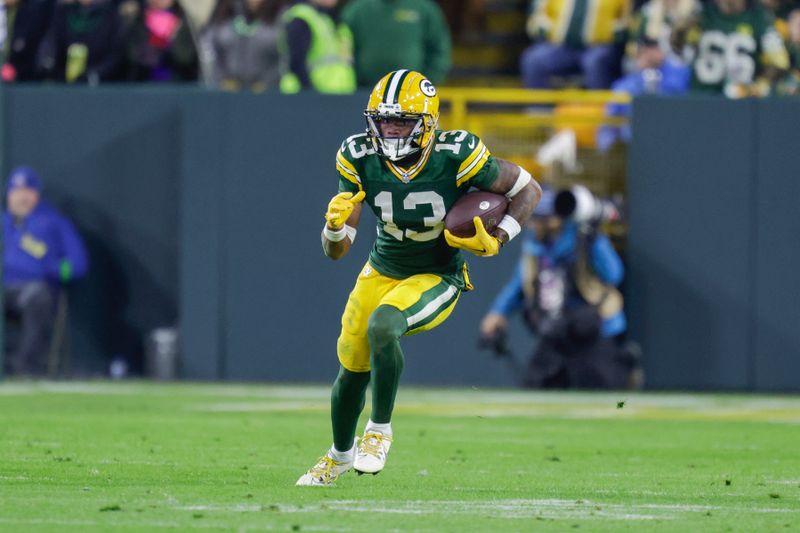 Green Bay Packers wide receiver Dontayvion Wicks (13) runs during an NFL football game between the Green Bay Packers and Chicago Bears Sunday, Jan. 7, 2024, in Green Bay, Wis. (AP Photo/Matt Ludtke)