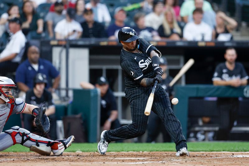 Jul 8, 2024; Chicago, Illinois, USA; Chicago White Sox catcher Martín Maldonado (15) hits a solo home run against the Minnesota Twins during the third inning at Guaranteed Rate Field. Mandatory Credit: Kamil Krzaczynski-USA TODAY Sports