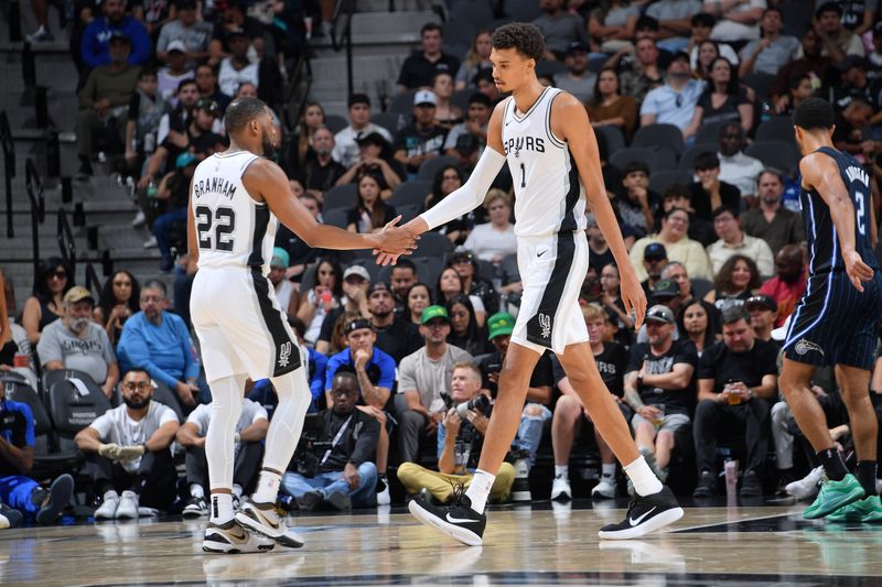 SAN ANTONIO, TX - OCTOBER 9: Victor Wembanyama #1 and Malaki Branham #22 of the San Antonio Spurs high five during the game against the Orlando Magic during a NBA preseason game on October 9, 2024 at the Frost Bank Center in San Antonio, Texas. NOTE TO USER: User expressly acknowledges and agrees that, by downloading and or using this photograph, user is consenting to the terms and conditions of the Getty Images License Agreement. Mandatory Copyright Notice: Copyright 2024 NBAE (Photos by Michael Gonzales/NBAE via Getty Images)