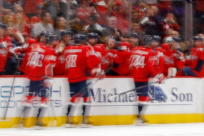 Oct 12, 2024; Washington, District of Columbia, USA; Washington Capitals defenseman John Carlson (74) celebrates with teammates after scoring a goal against the New Jersey Devils in the first period at Capital One Arena. Mandatory Credit: Geoff Burke-Imagn Images